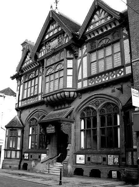 Half-timbering, Gothic Revival tracery and Jacobean carved porch brackets combine in the Tudor Revival Beaney Institute, Canterbury (1899)
